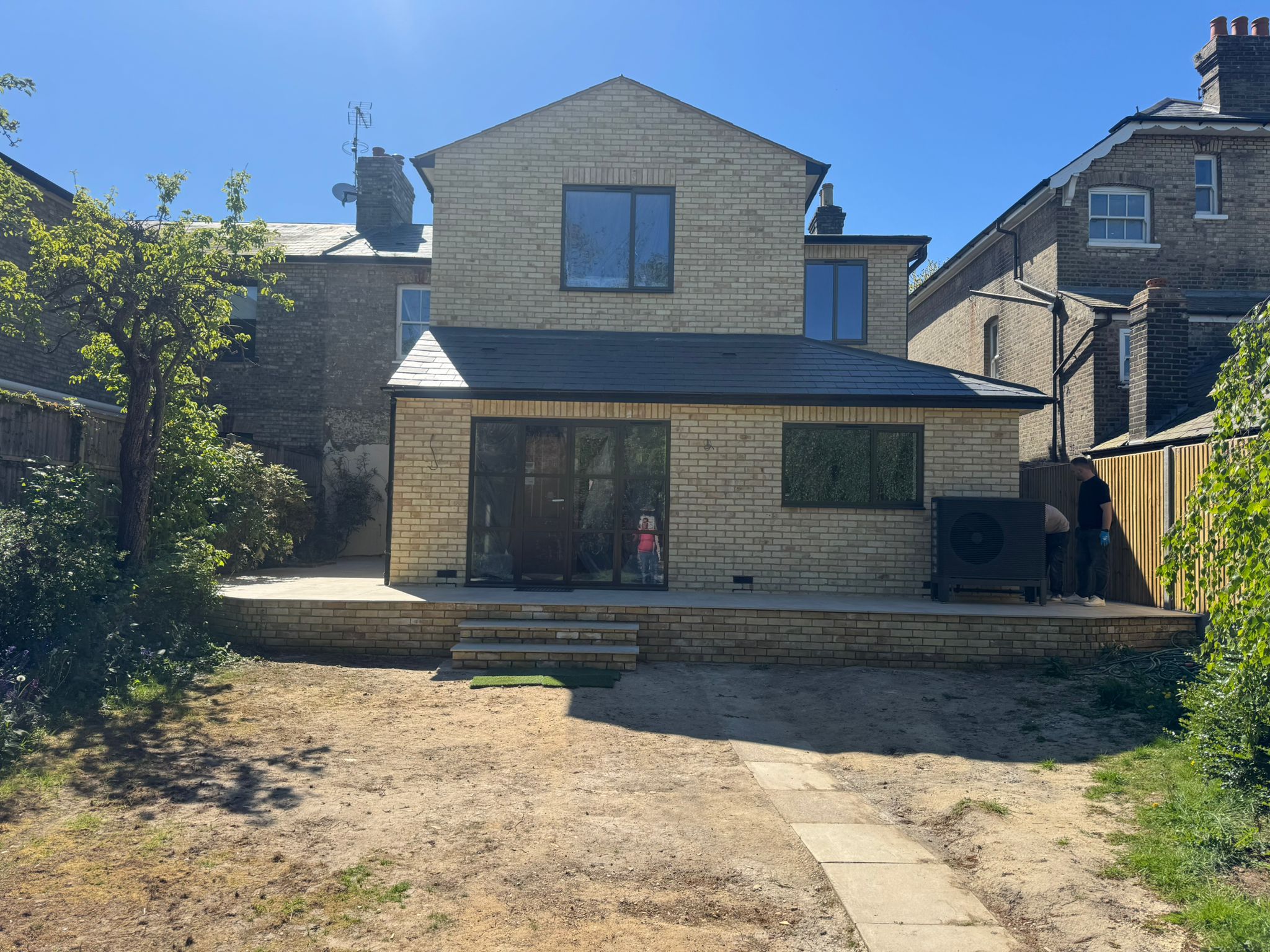 Finished rear extension in buff brick with anthracite bifold doors, by A&B Brickwork in North London