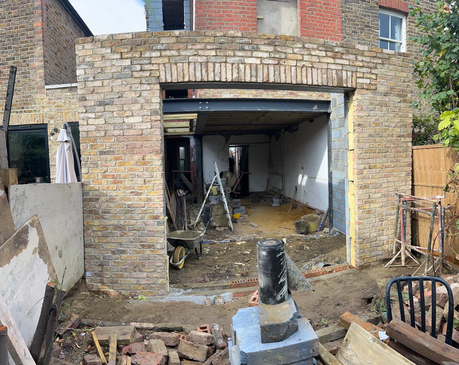 Stock brick rear extension with arched lintel opening