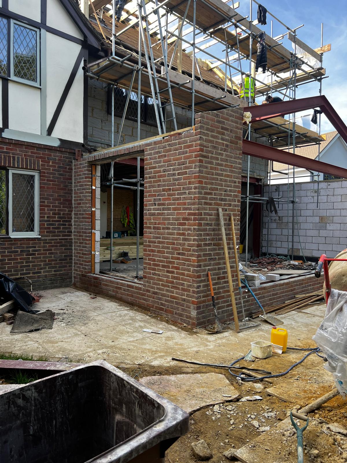 Stock brick extension matched to tudor style house