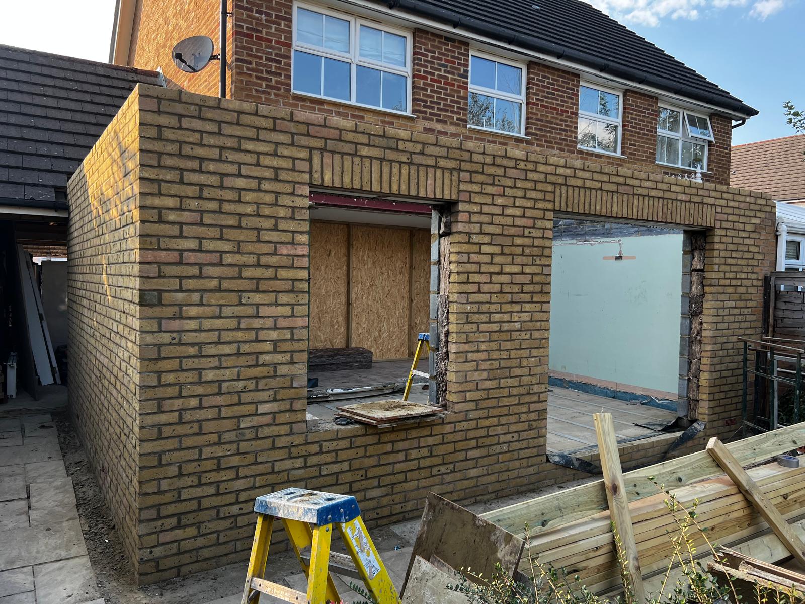 Yellow stock brick rear extension with door and window openings