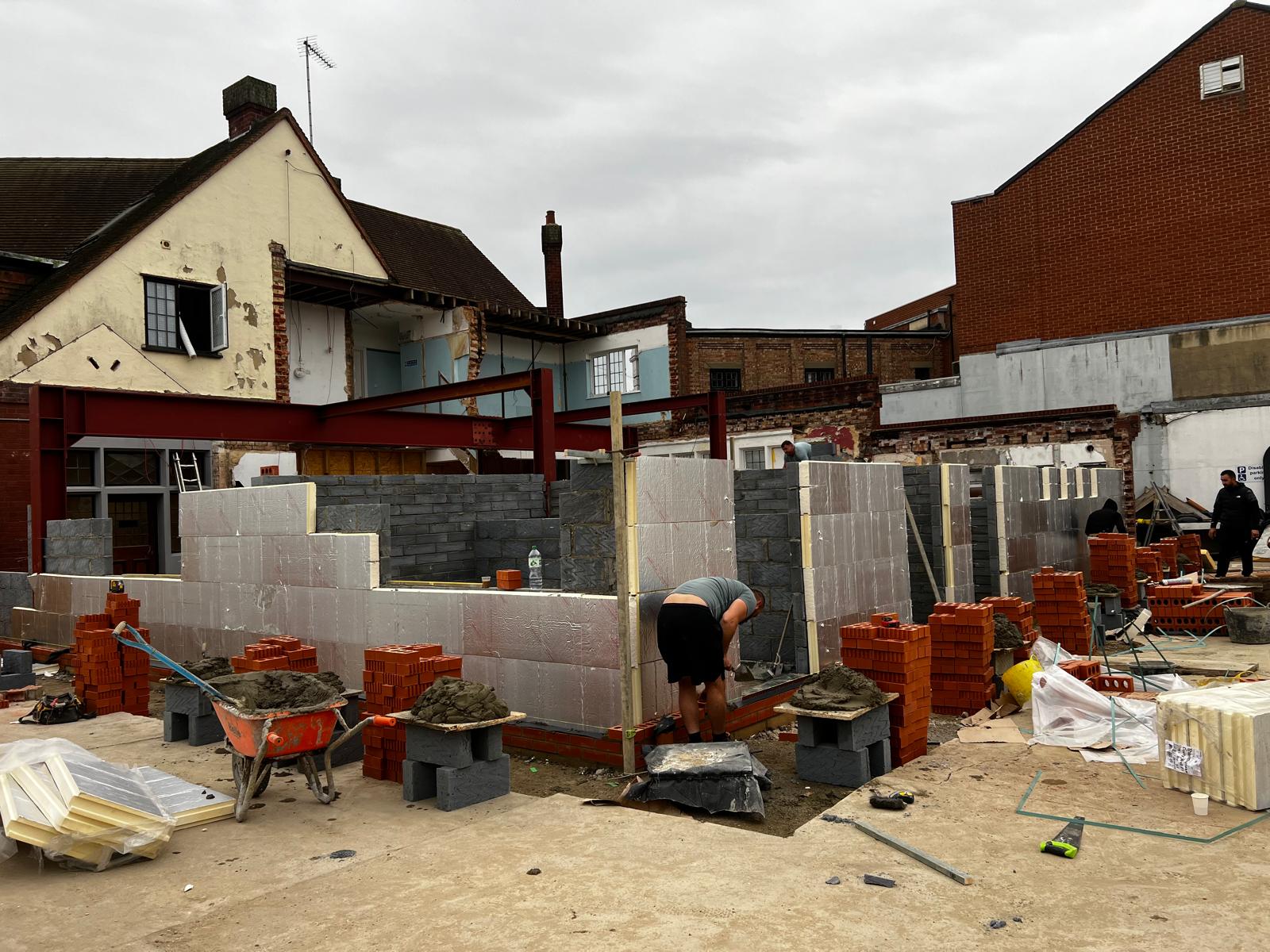Cavity walls rising on commercial extension with brick and insulation