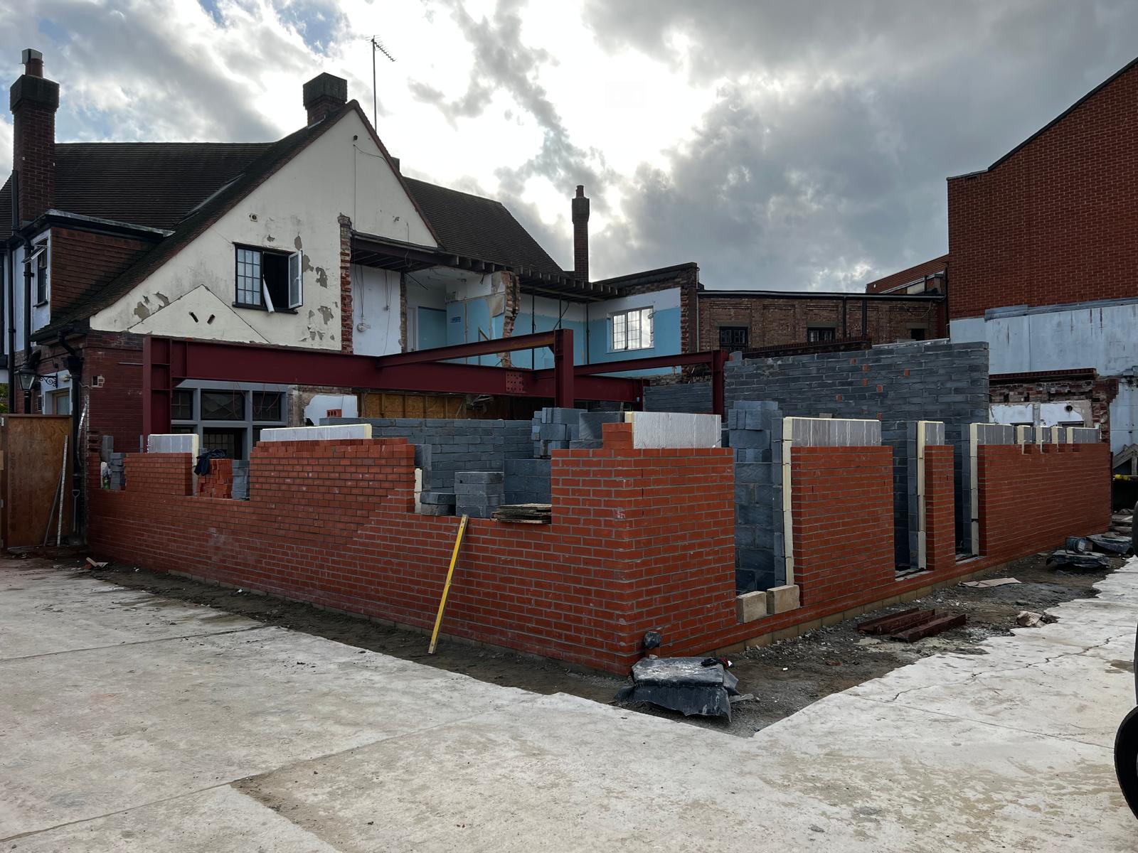 Red brick boundary wall completed in front of period property