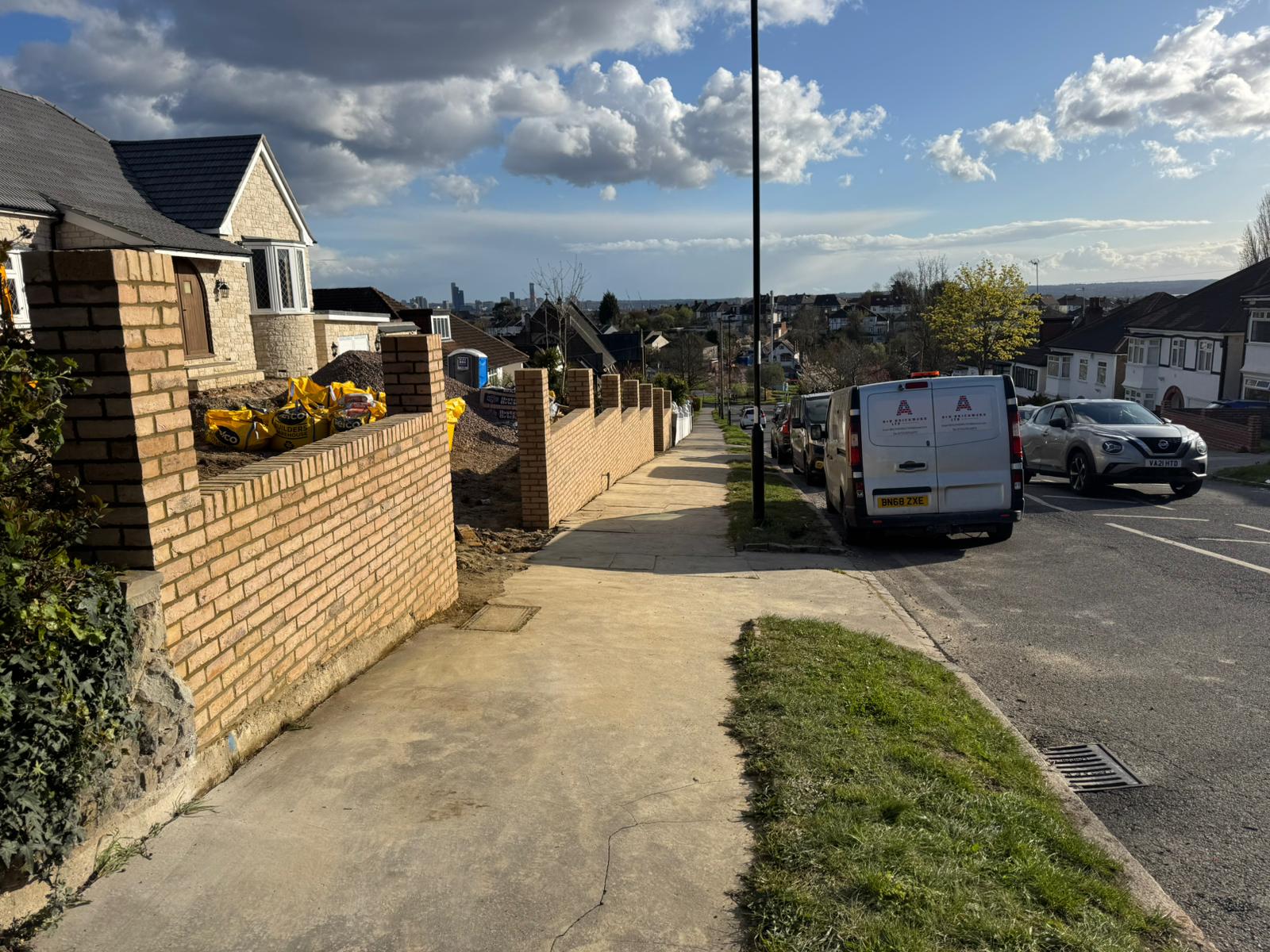 A&B Brickwork van parked next to brick wall with North London rooftop view